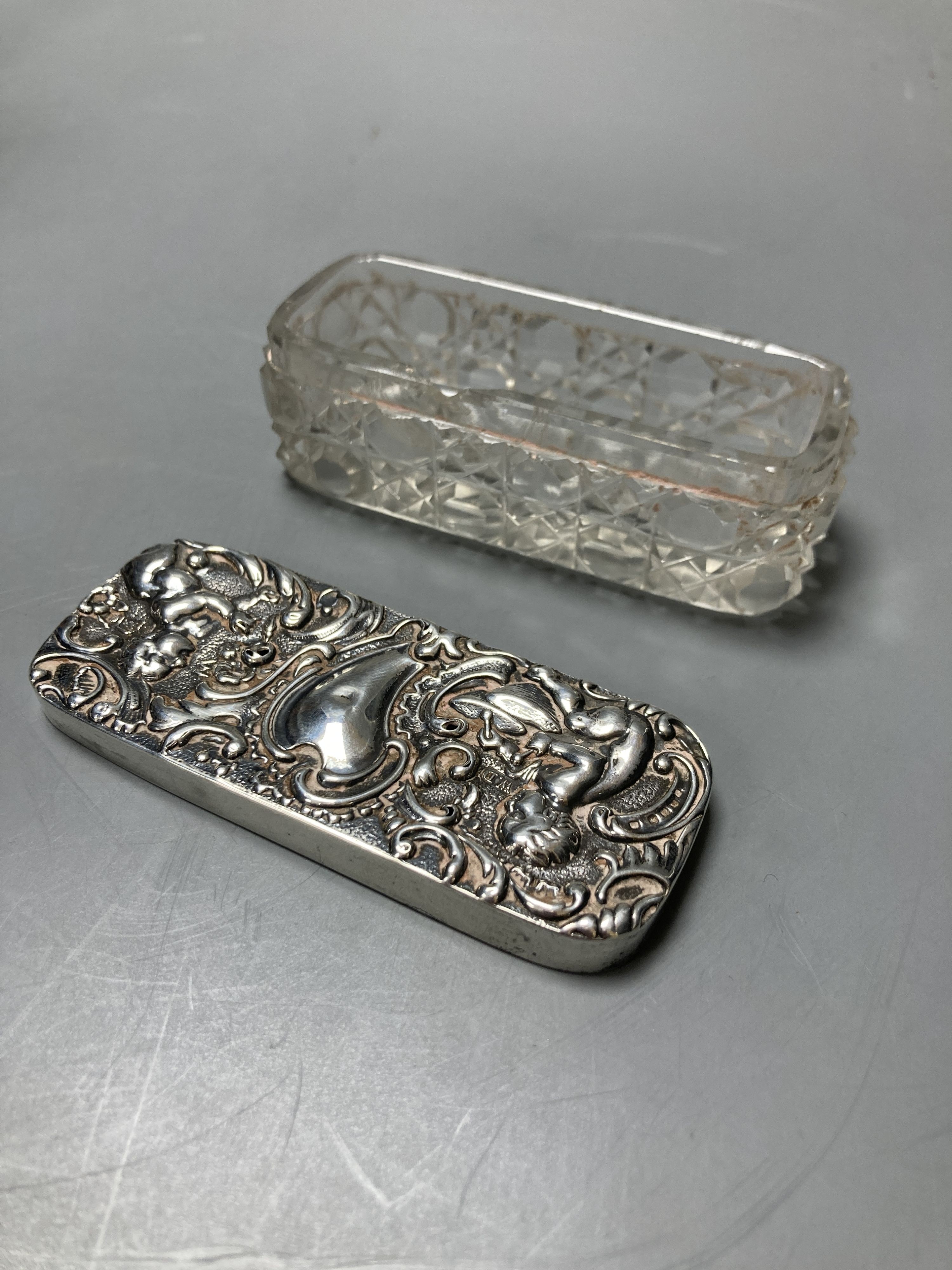 A silver cigar box, London 1928, 18cm, a silver ring box, Birmingham 1925, 9 cm diameter, and a silver topped pin box, 8.5 cm wide